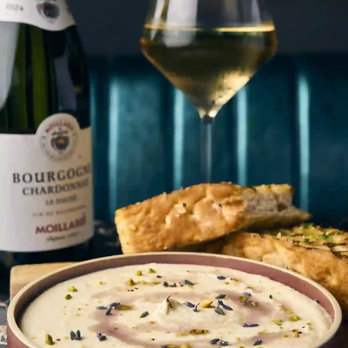 Lavender whipped feta with focaccia, a glass of white wine and a bottle of Bourgogne chardonnay